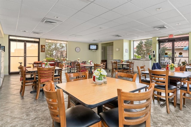 dining area featuring a paneled ceiling