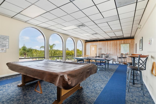 rec room with wooden walls, dark carpet, and billiards