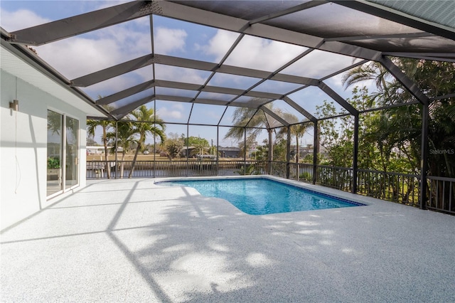 view of swimming pool with glass enclosure, a patio, and a water view