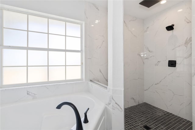 bathroom featuring a garden tub and a walk in shower