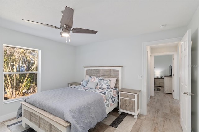 bedroom featuring baseboards, ceiling fan, and light wood finished floors