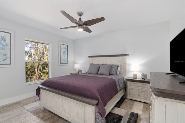 bedroom with light wood-type flooring and ceiling fan