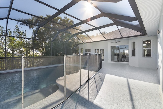 exterior space with glass enclosure, ceiling fan, and a patio area