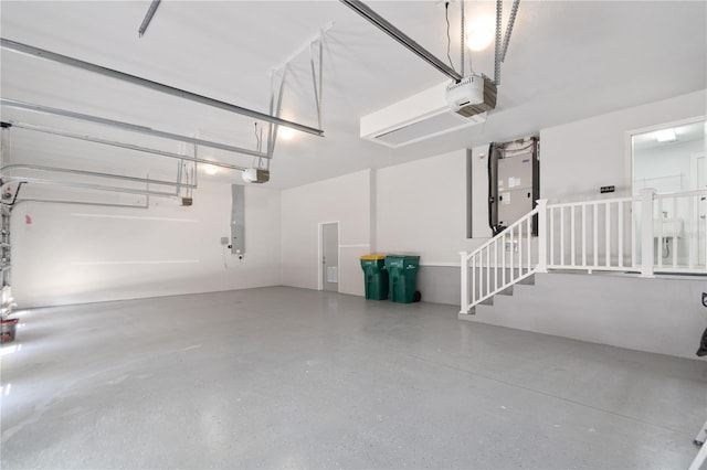 garage featuring a garage door opener and heating unit