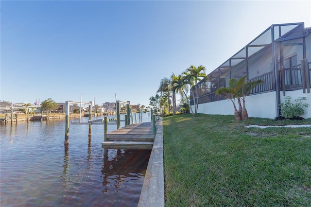 dock area featuring a water view and a lawn