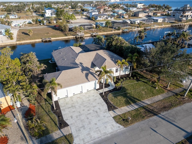 bird's eye view featuring a water view and a residential view