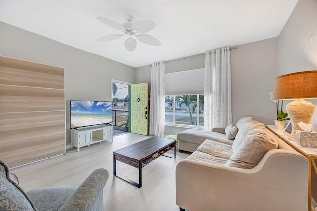 living room with light wood-type flooring and ceiling fan