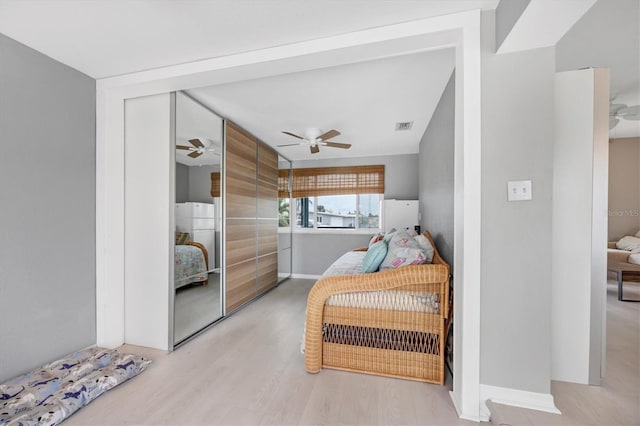 bedroom with light wood-type flooring and ceiling fan