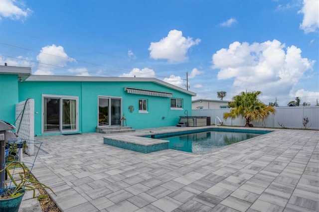 view of swimming pool with a patio area and a hot tub