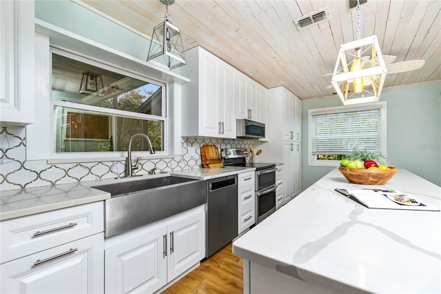 kitchen with white cabinetry, appliances with stainless steel finishes, decorative light fixtures, and wooden ceiling