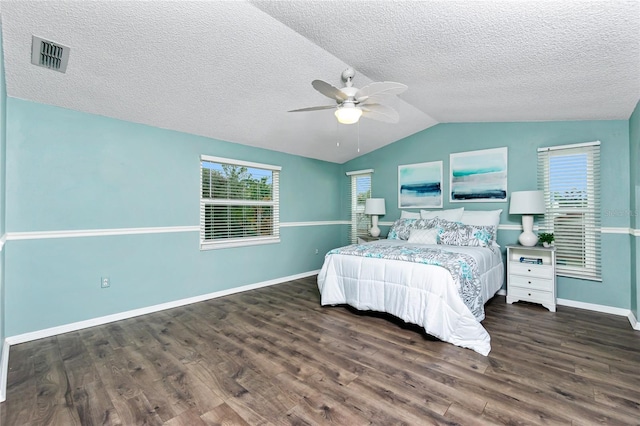 bedroom featuring lofted ceiling, a textured ceiling, dark hardwood / wood-style floors, and ceiling fan