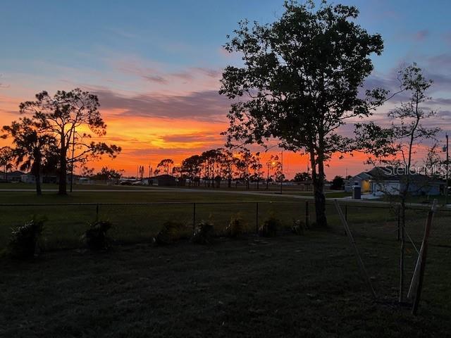 yard at dusk with a rural view