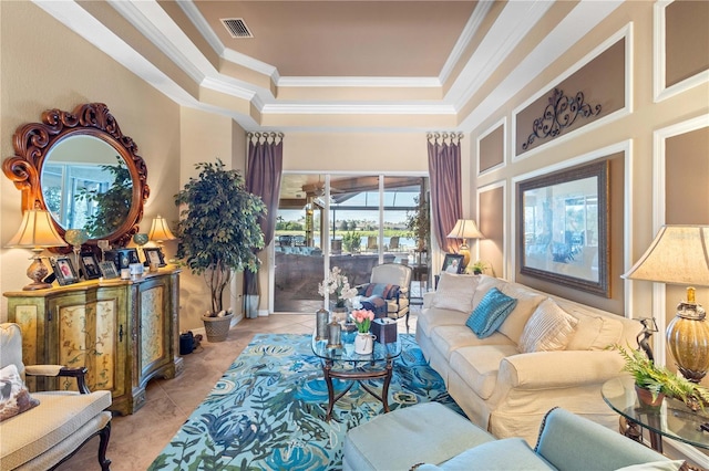 tiled living room featuring ornamental molding, a towering ceiling, and a tray ceiling