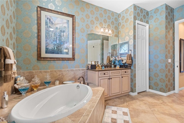 bathroom featuring vanity, tile patterned floors, and tiled tub