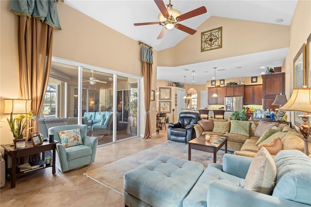 living room featuring light tile patterned flooring, ceiling fan with notable chandelier, and high vaulted ceiling