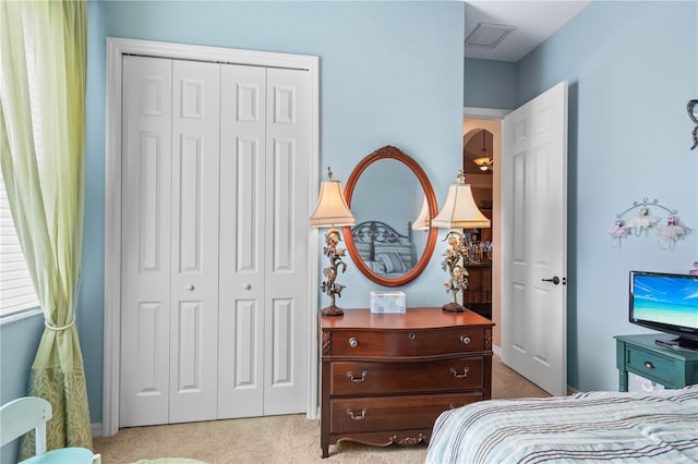 carpeted bedroom with a closet