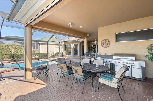 view of patio / terrace with area for grilling and a lanai