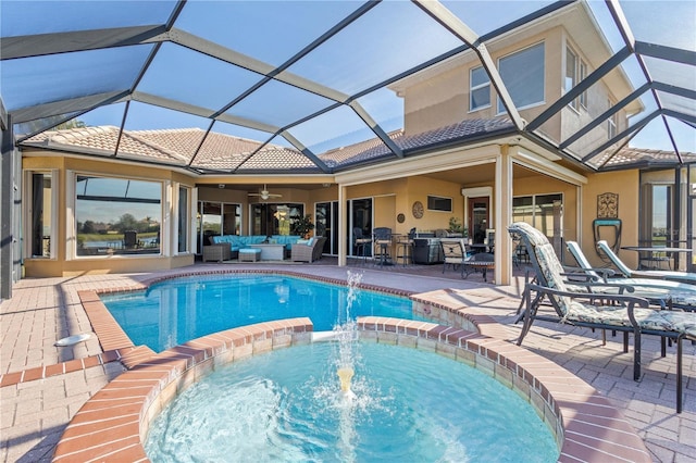 view of pool with an in ground hot tub, a lanai, an outdoor living space, ceiling fan, and a patio area