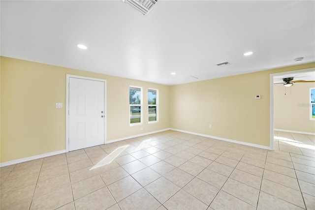 spare room featuring ceiling fan and light tile patterned flooring