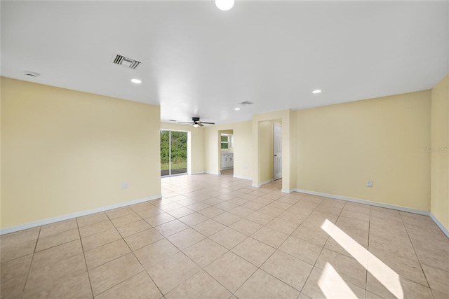 unfurnished room with ceiling fan and light tile patterned flooring