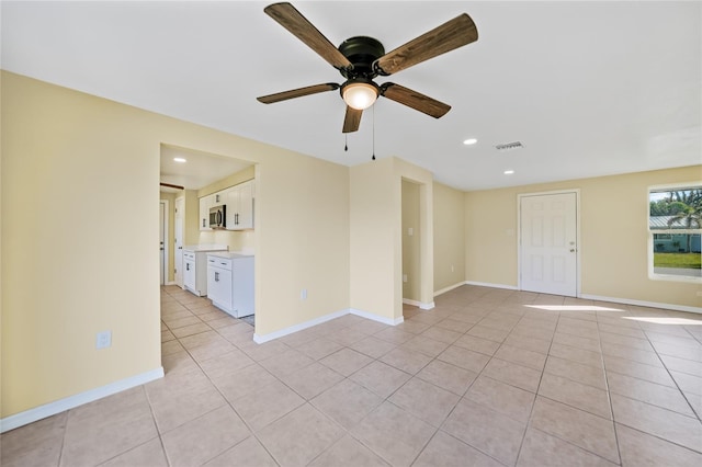 unfurnished room with ceiling fan and light tile patterned floors