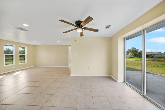 tiled empty room with ceiling fan