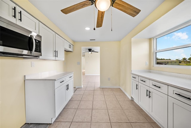 kitchen with white cabinetry and light tile patterned floors