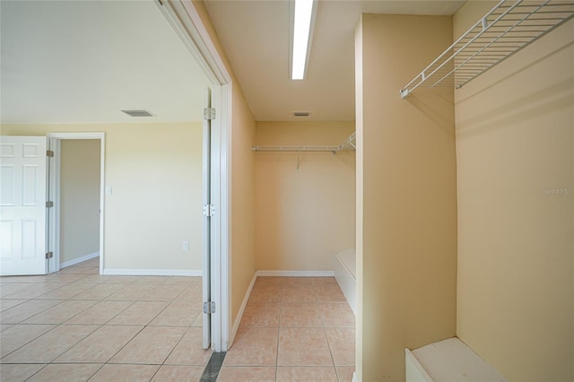 spacious closet featuring light tile patterned floors