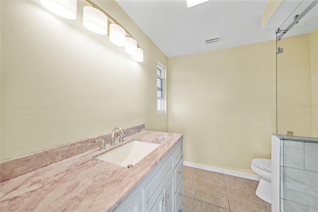 bathroom featuring tile patterned floors, vanity, and toilet