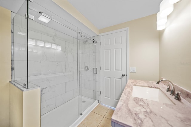 bathroom with tile patterned floors, vanity, and a shower with door