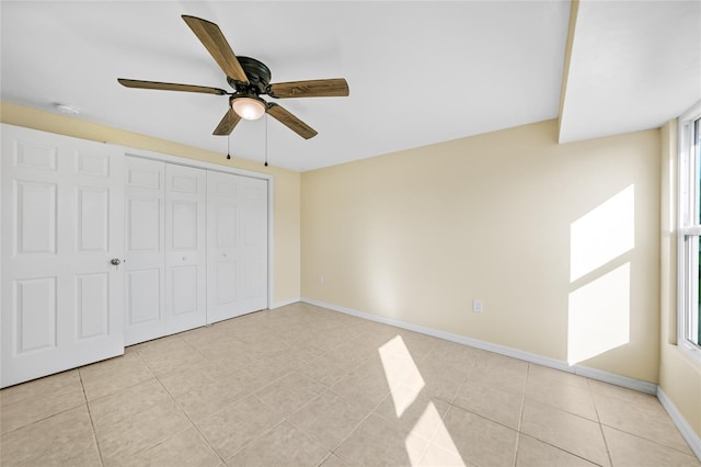 unfurnished bedroom with multiple windows, ceiling fan, and light tile patterned flooring