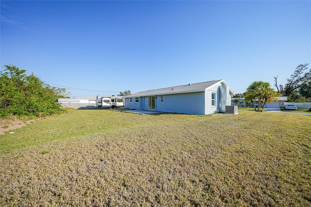 exterior space featuring a patio, cooling unit, and a lawn