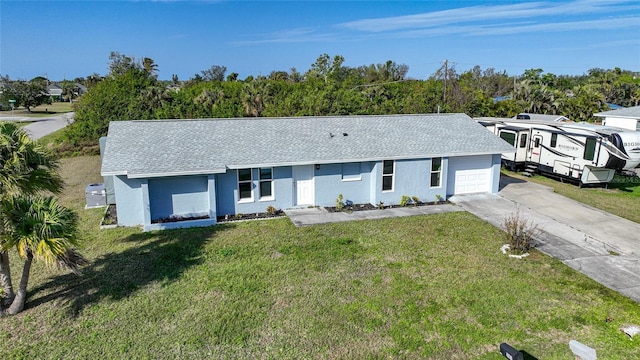 view of front of home with a front lawn and a garage