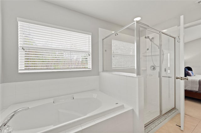 bathroom with tile patterned flooring and independent shower and bath