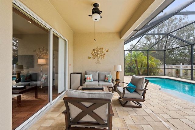 view of patio featuring a fenced in pool, outdoor lounge area, and glass enclosure