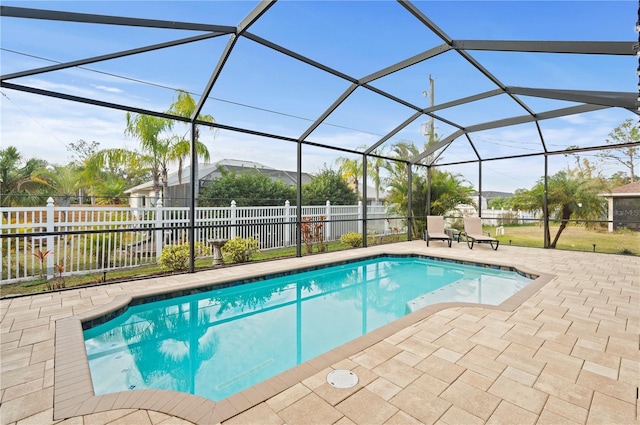 view of swimming pool featuring a lanai and a patio area