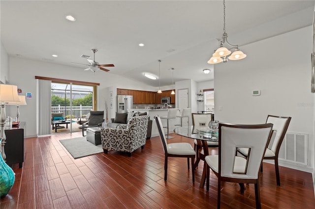 dining room with vaulted ceiling, dark hardwood / wood-style floors, and ceiling fan