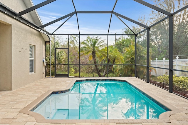 view of swimming pool with a lanai and a patio area