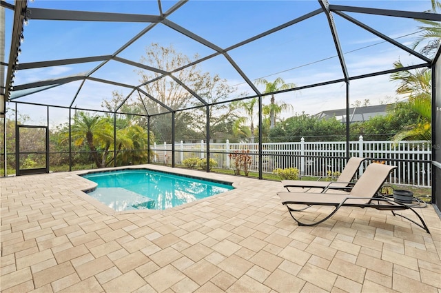 view of pool with a patio and glass enclosure