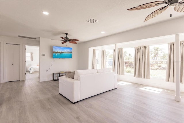 unfurnished living room with light hardwood / wood-style floors and ceiling fan