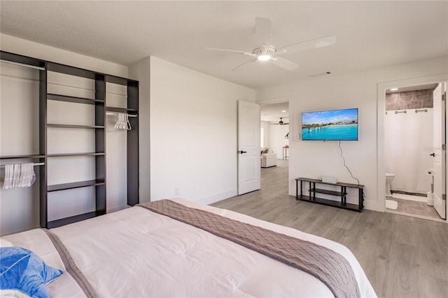 bedroom with connected bathroom, ceiling fan, a closet, and light wood-type flooring