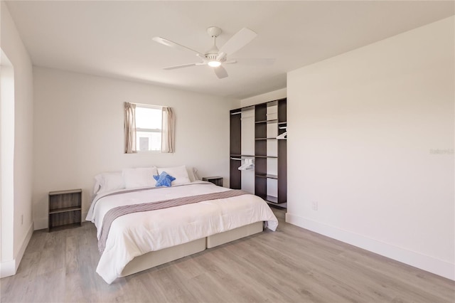 bedroom with ceiling fan and light hardwood / wood-style flooring