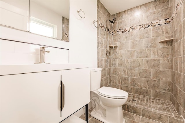 bathroom featuring tiled shower and toilet