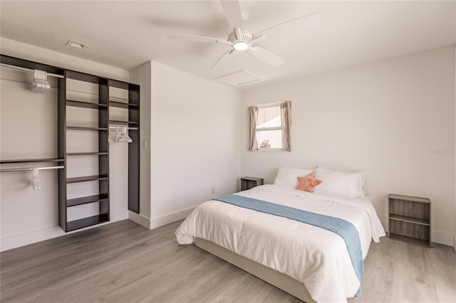 bedroom with ceiling fan, a closet, and light wood-type flooring