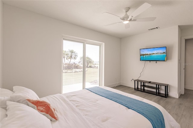 bedroom with access to exterior, light wood-type flooring, and ceiling fan