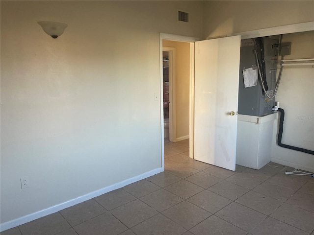 unfurnished bedroom featuring a closet and light tile patterned flooring