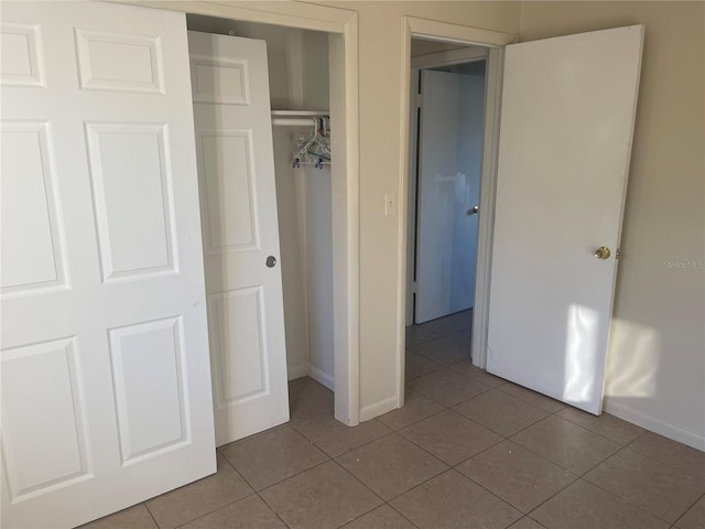 unfurnished bedroom featuring tile patterned floors and a closet