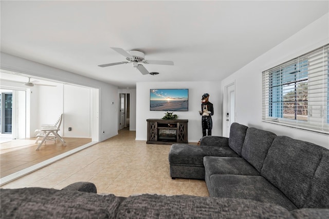 tiled living room with ceiling fan