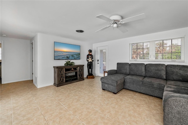 tiled living room featuring ceiling fan