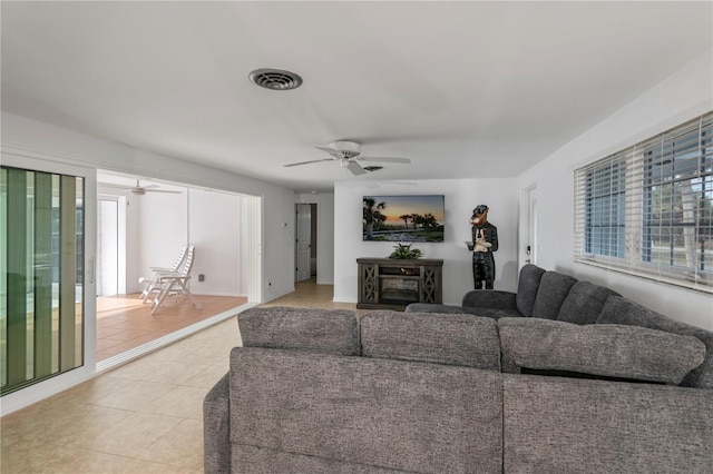 tiled living room with ceiling fan